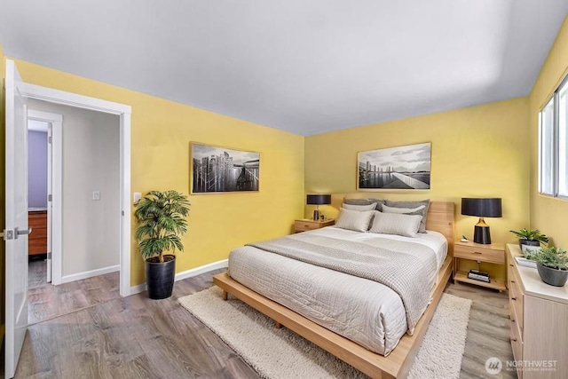 bedroom featuring baseboards and wood finished floors