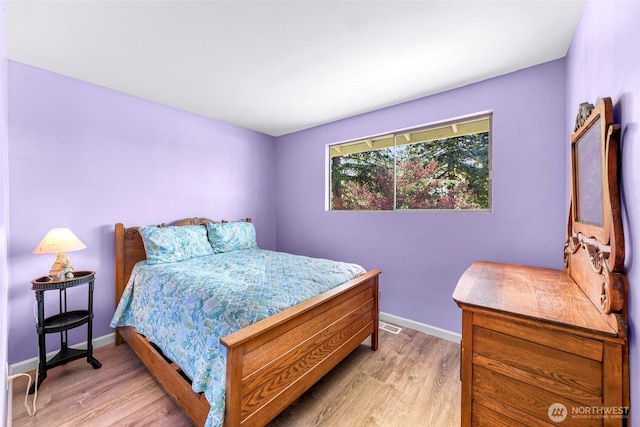 bedroom with baseboards and light wood-style flooring