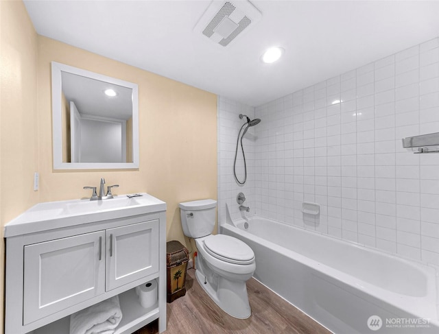 bathroom featuring bathing tub / shower combination, toilet, visible vents, wood finished floors, and vanity