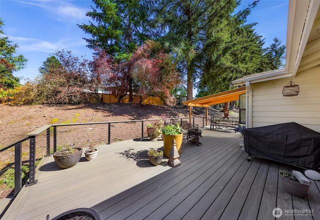 deck with area for grilling and fence