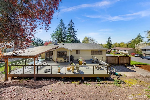 rear view of house featuring a deck