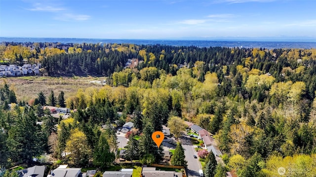 drone / aerial view with a residential view and a wooded view