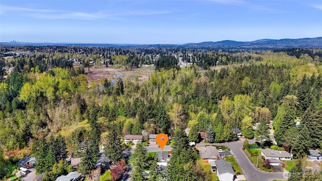 bird's eye view featuring a wooded view and a mountain view