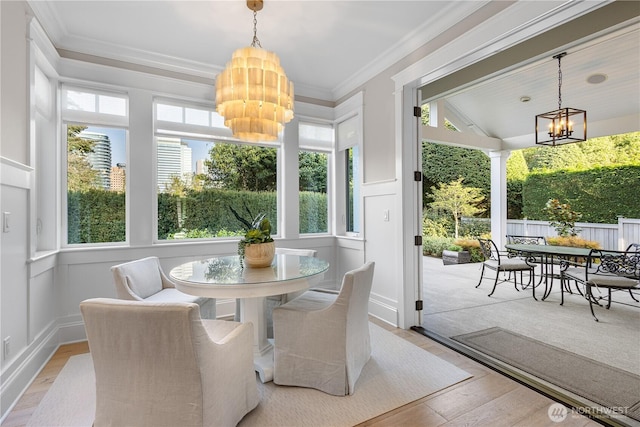 sunroom / solarium featuring a notable chandelier and a wealth of natural light