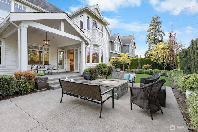 view of patio / terrace with an outdoor living space with a fire pit