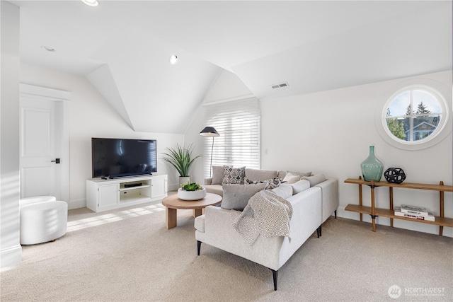 living area featuring visible vents, baseboards, vaulted ceiling, and light carpet