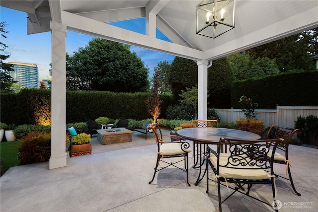 view of patio / terrace featuring fence, outdoor dining space, and an outdoor fire pit