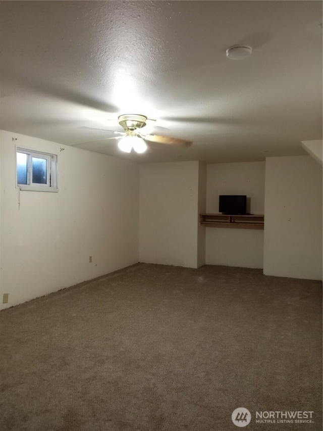 spare room with carpet floors and ceiling fan