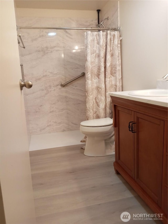 full bath featuring vanity, wood finished floors, toilet, and a shower with curtain