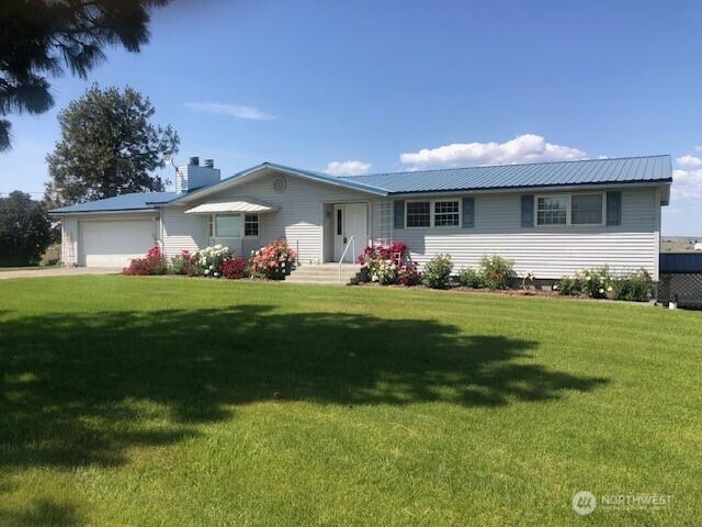 20868 SE Rd 2, Warden, WA 98857 - ranch-style house featuring a garage, a front lawn, and a metal roof