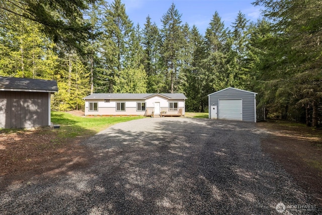 18142 NE Diamond Rd, Poulsbo, WA 98370 - view of front of home featuring a wooded view, aphalt driveway, a garage, and an outdoor structure