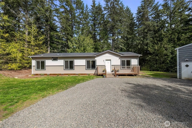 18142 NE Diamond Rd, Poulsbo, WA 98370 - view of front of home with gravel driveway, crawl space, a wooden deck, and a front lawn