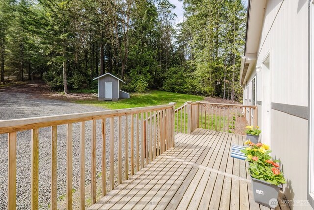 18142 NE Diamond Rd, Poulsbo, WA 98370 - wooden terrace with a yard, a storage unit, and an outdoor structure