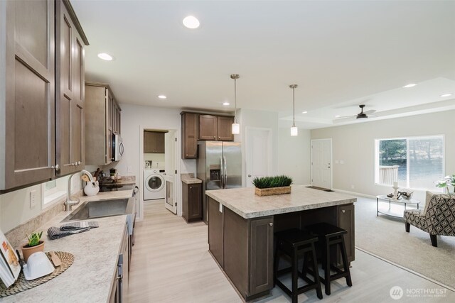 18142 NE Diamond Rd, Poulsbo, WA 98370 - kitchen featuring recessed lighting, light wood-type flooring, washer / clothes dryer, and appliances with stainless steel finishes