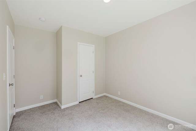 18142 NE Diamond Rd, Poulsbo, WA 98370 - unfurnished room with light colored carpet and baseboards