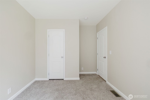18142 NE Diamond Rd, Poulsbo, WA 98370 - unfurnished bedroom featuring light carpet, baseboards, and visible vents