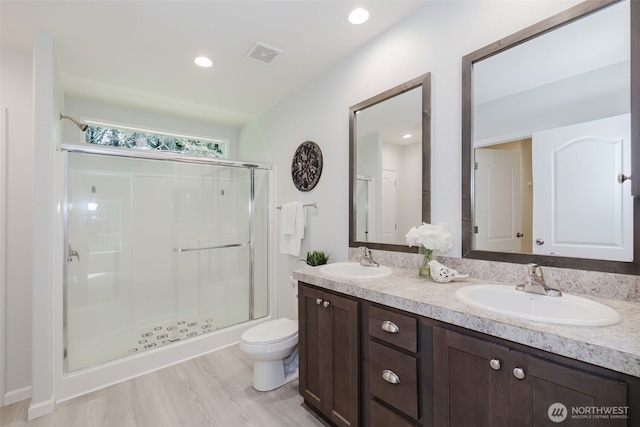 18142 NE Diamond Rd, Poulsbo, WA 98370 - bathroom featuring toilet, a stall shower, a sink, and visible vents