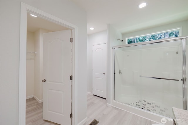 18142 NE Diamond Rd, Poulsbo, WA 98370 - bathroom with a shower stall, wood finished floors, baseboards, and recessed lighting