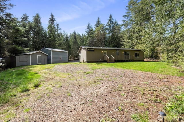 18142 NE Diamond Rd, Poulsbo, WA 98370 - view of yard featuring an outbuilding and a shed
