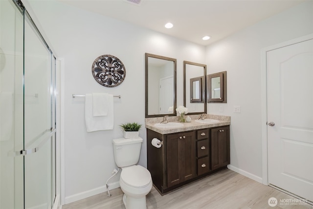 18142 NE Diamond Rd, Poulsbo, WA 98370 - full bathroom with baseboards, wood finished floors, a sink, and a stall shower