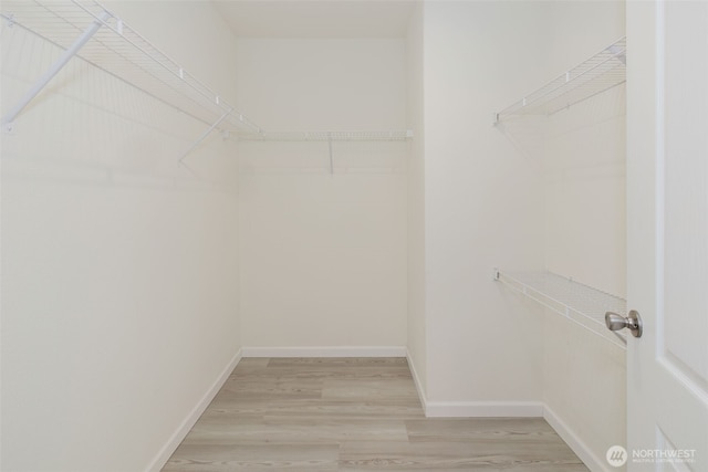 18142 NE Diamond Rd, Poulsbo, WA 98370 - walk in closet with light wood-style floors