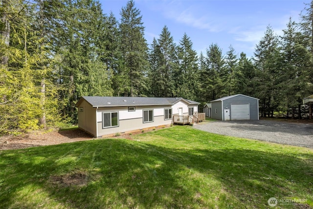 18142 NE Diamond Rd, Poulsbo, WA 98370 - view of front of house featuring a detached garage, crawl space, an outdoor structure, a front lawn, and gravel driveway