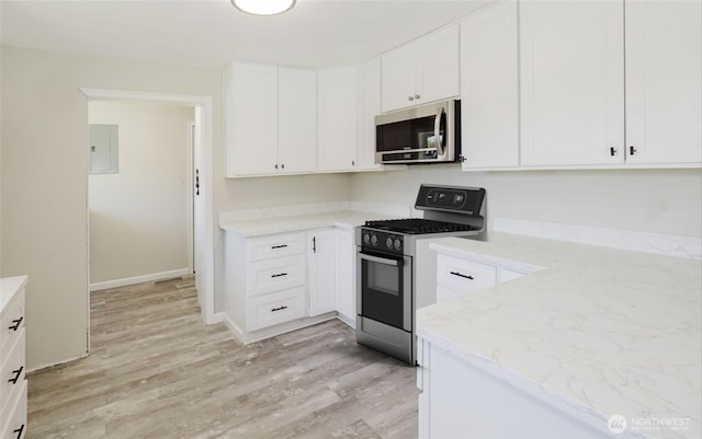 3335 Trenton Ave NE, Bremerton, WA 98310 - kitchen featuring stainless steel appliances, light wood-style floors, white cabinets, and light stone counters