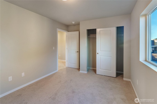 18218 37th Ave E, Tacoma, WA 98446 - unfurnished bedroom with a closet, baseboards, and light carpet