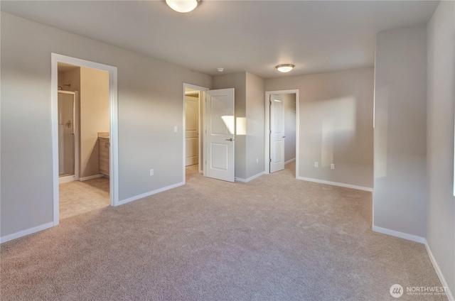 18218 37th Ave E, Tacoma, WA 98446 - unfurnished bedroom featuring light carpet, a walk in closet, and baseboards