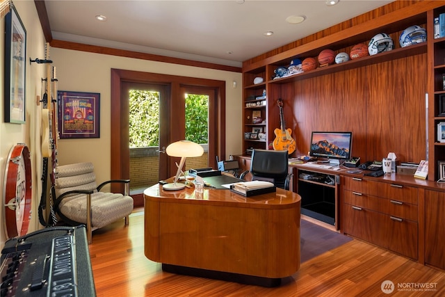 office featuring recessed lighting, built in shelves, and light wood-style floors