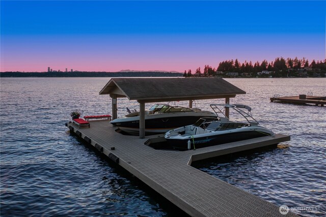 dock area with a water view and boat lift