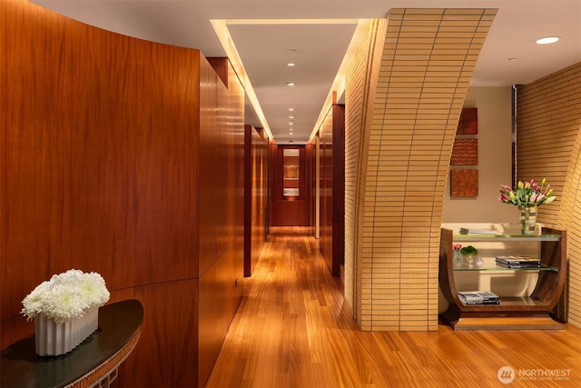 hallway with wood finished floors and recessed lighting