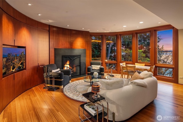living room with light wood-style flooring, a fireplace, and recessed lighting