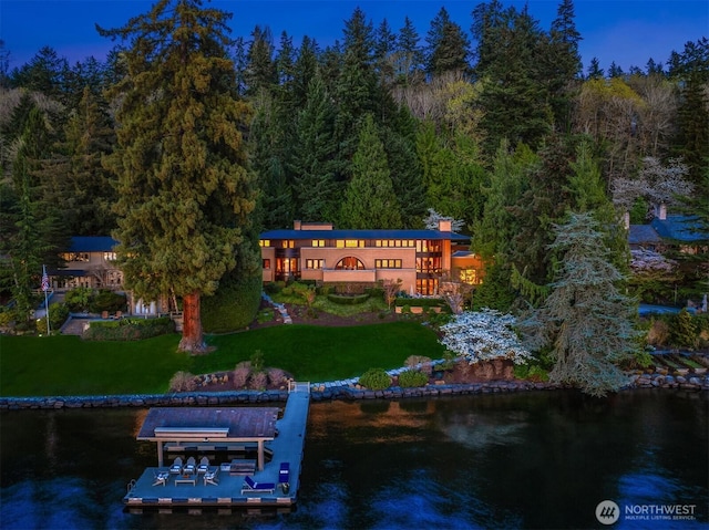 exterior space with a wooded view and a water view