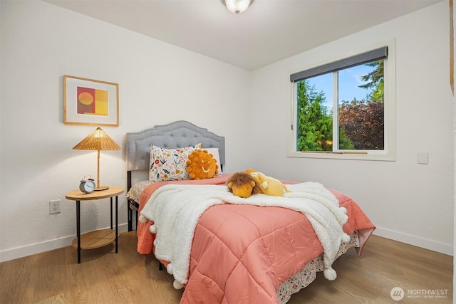 bedroom featuring baseboards and wood finished floors