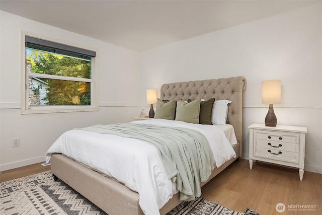 bedroom with wood finished floors and baseboards