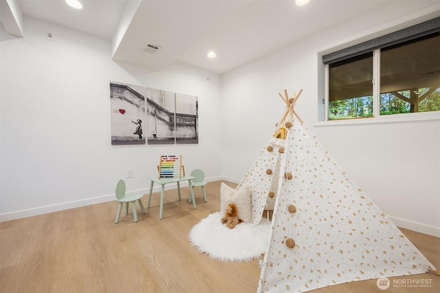 playroom featuring wood finished floors, recessed lighting, and baseboards