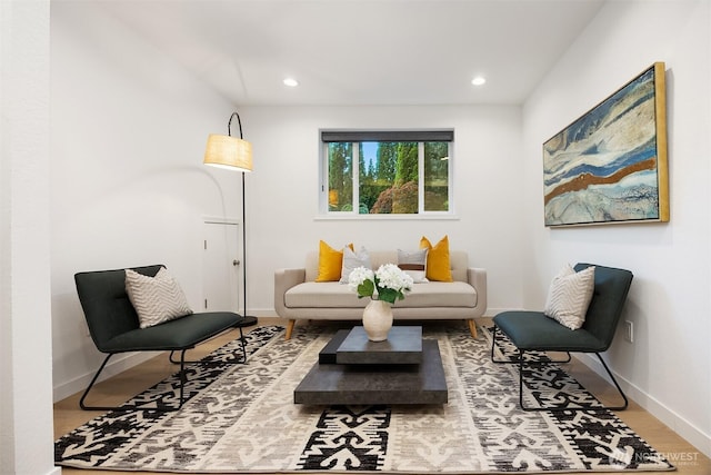 living area featuring baseboards, recessed lighting, and wood finished floors