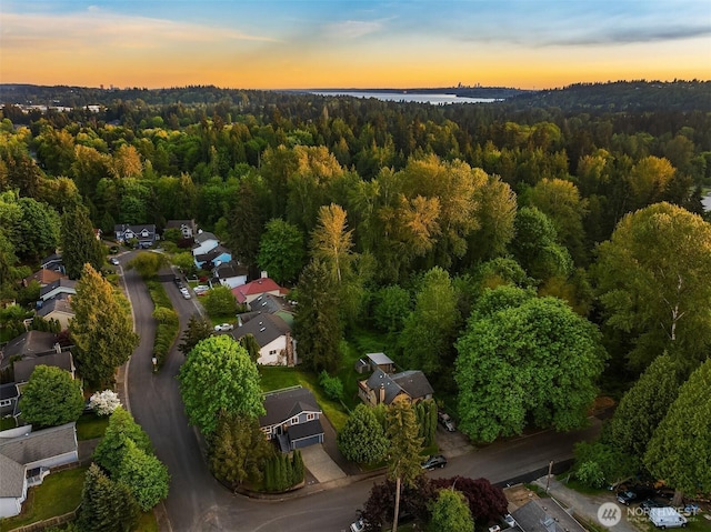 aerial view at dusk of a view of trees and a residential view