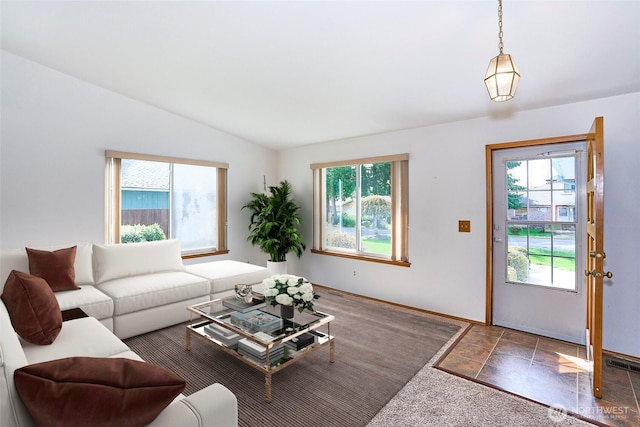 21850 SE 271st Pl, Maple Valley, WA 98038 - living room featuring stone finish floor, visible vents, baseboards, and vaulted ceiling