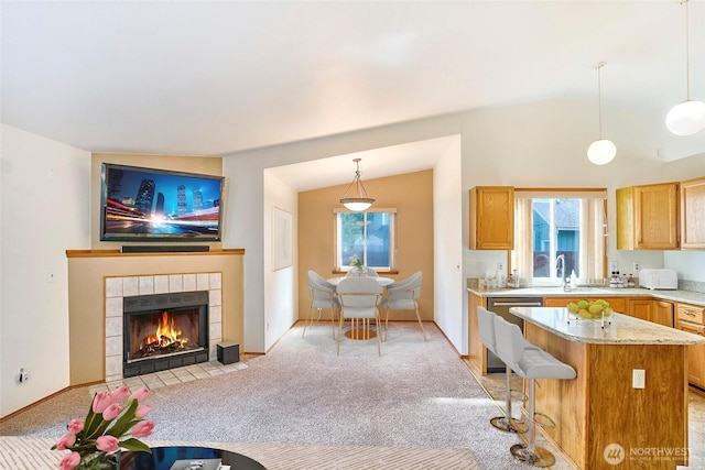 21850 SE 271st Pl, Maple Valley, WA 98038 - interior space with a tiled fireplace, stainless steel dishwasher, vaulted ceiling, and light carpet