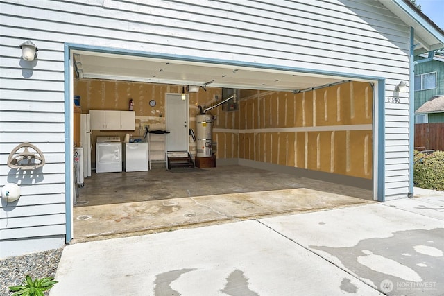 21850 SE 271st Pl, Maple Valley, WA 98038 - garage with washer and clothes dryer, secured water heater, freestanding refrigerator, and concrete driveway