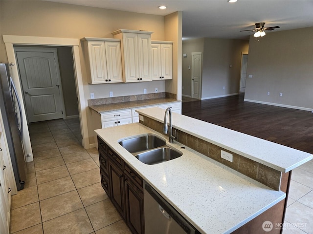 kitchen featuring recessed lighting, an island with sink, a sink, appliances with stainless steel finishes, and open floor plan