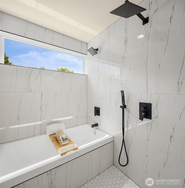bathroom with a marble finish shower, tiled tub, and tile walls