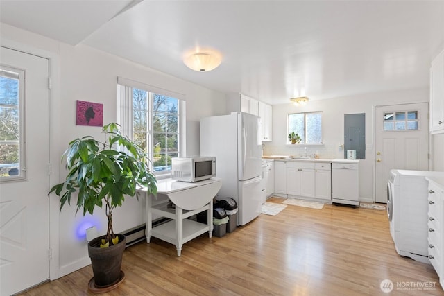 14043 Burke Ave N, Seattle, WA 98133 - kitchen featuring white appliances, washer / clothes dryer, tasteful backsplash, white cabinetry, and light countertops