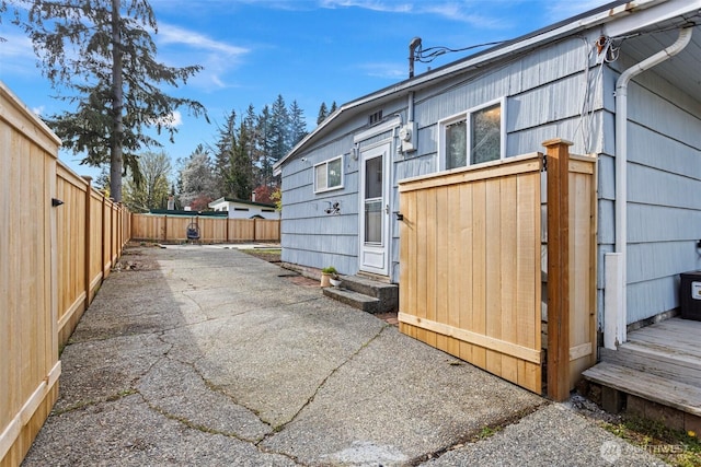 14043 Burke Ave N, Seattle, WA 98133 - view of side of home featuring entry steps, a fenced backyard, and a patio area