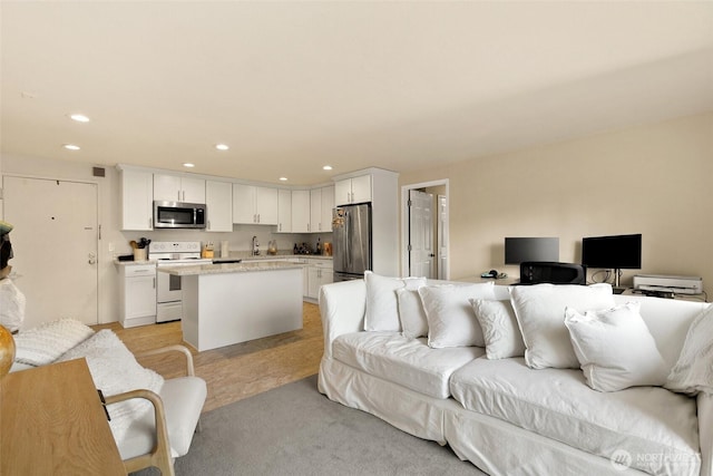 living room featuring recessed lighting and light colored carpet