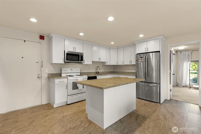 kitchen featuring white cabinets, stainless steel appliances, recessed lighting, and a sink