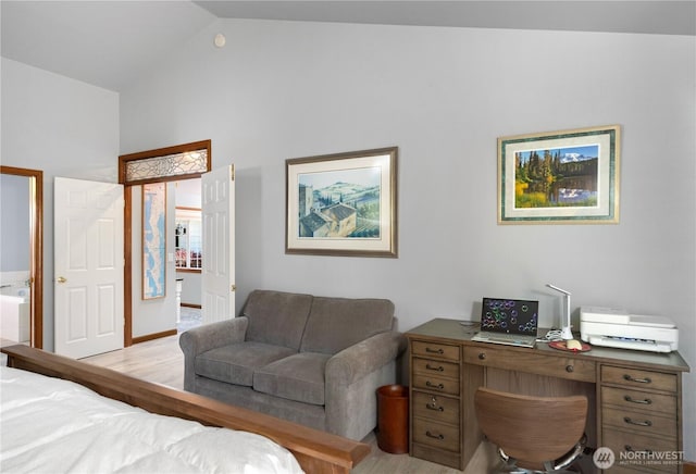 bedroom with vaulted ceiling and light wood-style floors