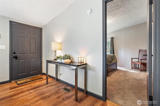 151 Deer Haven Dr, Winlock, WA 98596 - entrance foyer featuring baseboards, visible vents, wood finished floors, and a textured ceiling